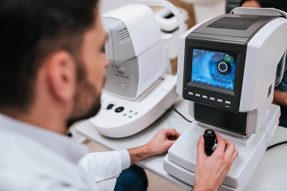 Doctor working with a high-tech optometry machine