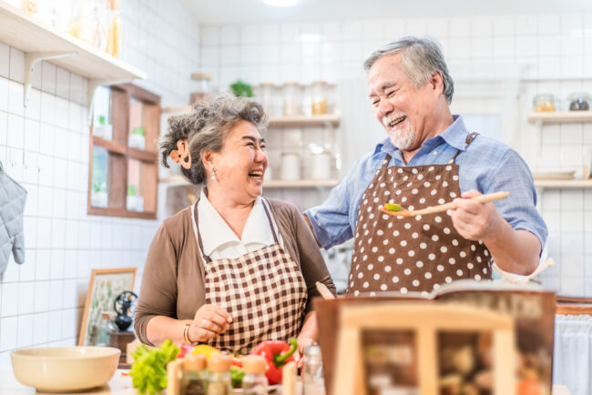 Happy senior couple cooking together