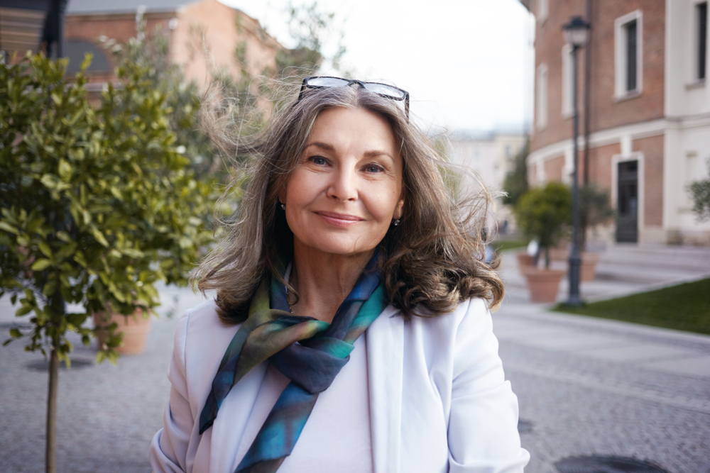 Stylish senior woman with glasses on her head