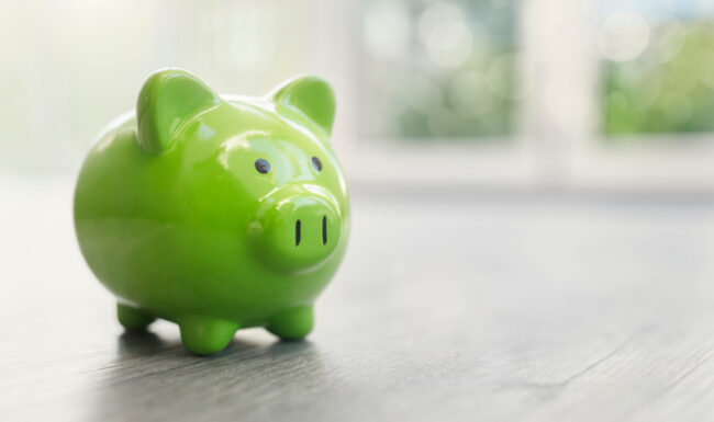 Green piggy bank on light table