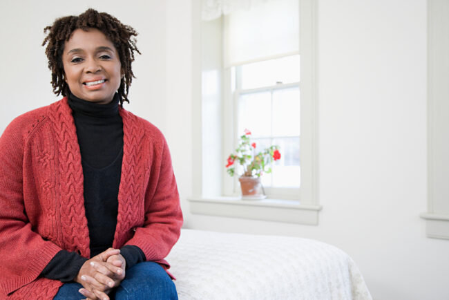 Woman wearing a red sweater with white background