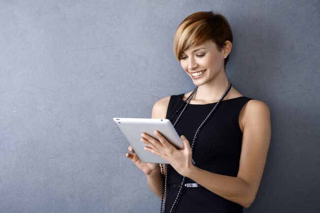 woman looking at tablet